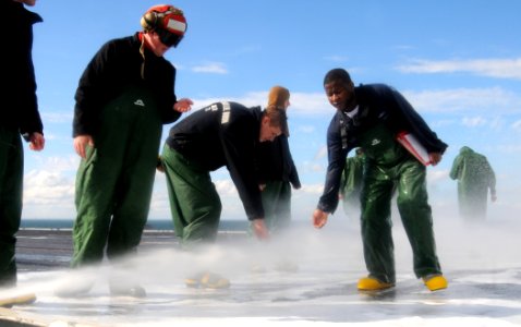 US Navy 101201-N-6632S-161 Sailors check water for the presence of aqueous film forming foam during a countermeasure washdown on the flight deck of