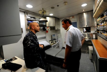 US Navy 101202-N-2984R-235 Adm. Edmundo Gonzales Robles speaks to Hospital Corpsman 1st Class Michael Loeffler inside the High Speed Vessel Swift (