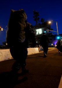 US Navy 101130-N-2055M-159 Sailors assigned to the aircraft carrier USS Carl Vinson (CVN 70) board the ship before Carl Vinson departs Naval Air St