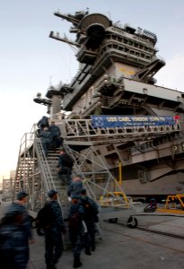 US Navy 101130-N-7981E-252 Sailors board the aircraft carrier USS Carl Vinson (CVN 70)