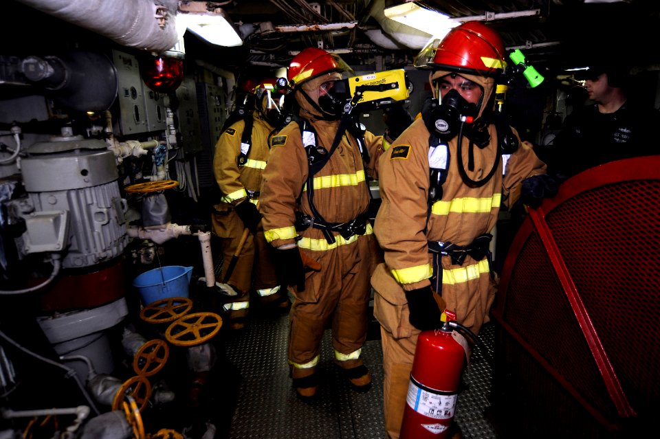 US Navy 101202-N-8335D-043 A four-man assessment team ensures a simulated fire is out in main machinery room No. 1 during a general quarters drill