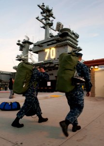 US Navy 101130-N-7981E-186 Sailors board the aircraft carrier USS Carl Vinson (CVN 70)