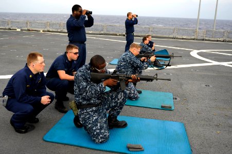 US Navy 101130-N-8335D-247 Sailors fire M-16 rifles during a live-fire exercise aboard the amphibious dock landing ship USS Tortuga (LSD 46) photo