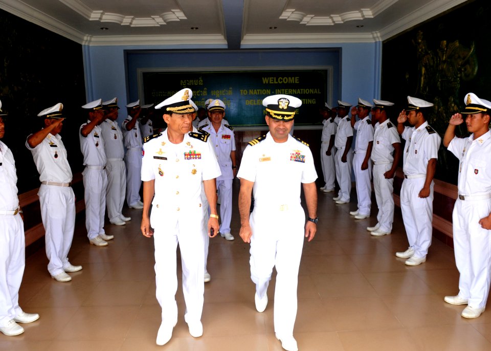 US Navy 101203-N-8721D-101 Cmdr. Michael V. Misiewicz, commanding officer of the guided-missile destroyer USS Mustin (DDG 89), is escorted by Cambo