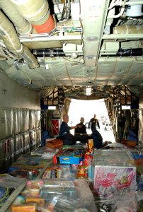 US Navy 101203-N-0092J-148 Sailors and Marines assigned to the U.S. Navy flight demonstration squadron, the Blue Angels, load pallets filled with t