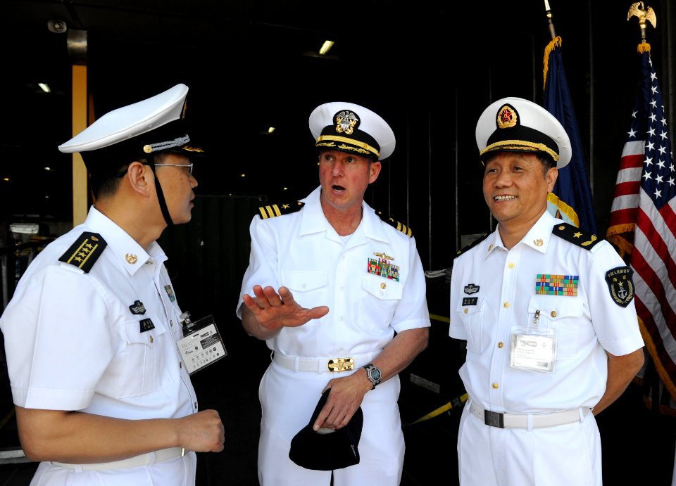 US Navy 101201-N-7589W-046 Cmdr. Mark Becker, center, mission commander of Southern Partnership Station 2011, speaks with People's Liberation Army