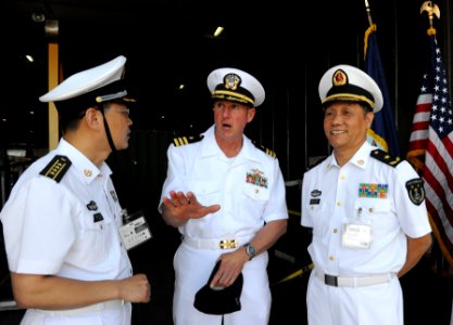 US Navy 101201-N-7589W-046 Cmdr. Mark Becker, center, mission commander of Southern Partnership Station 2011, speaks with People's Liberation Army photo