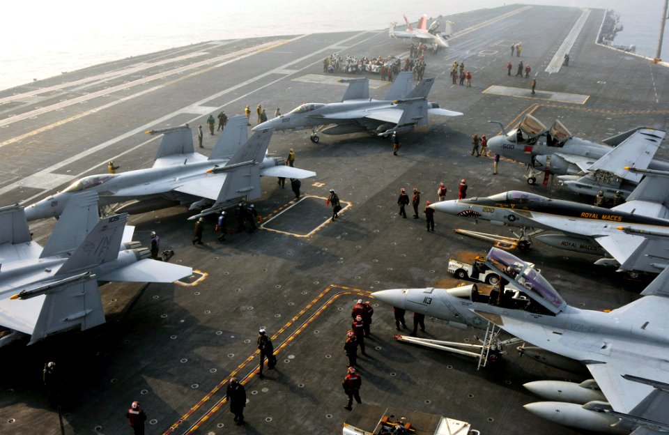 US Navy 101130-N-7103C-071 aboard the aircraft carrier USS George Washington (CVN 73) position aircraft on the flight deck during flight operations