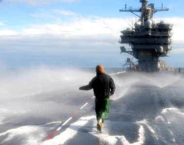 US Navy 101201-N-6632S-213 Damage Controlman Fireman Richard Dye checks sprinklers during a countermeasure washdown on the flight deck of the aircr