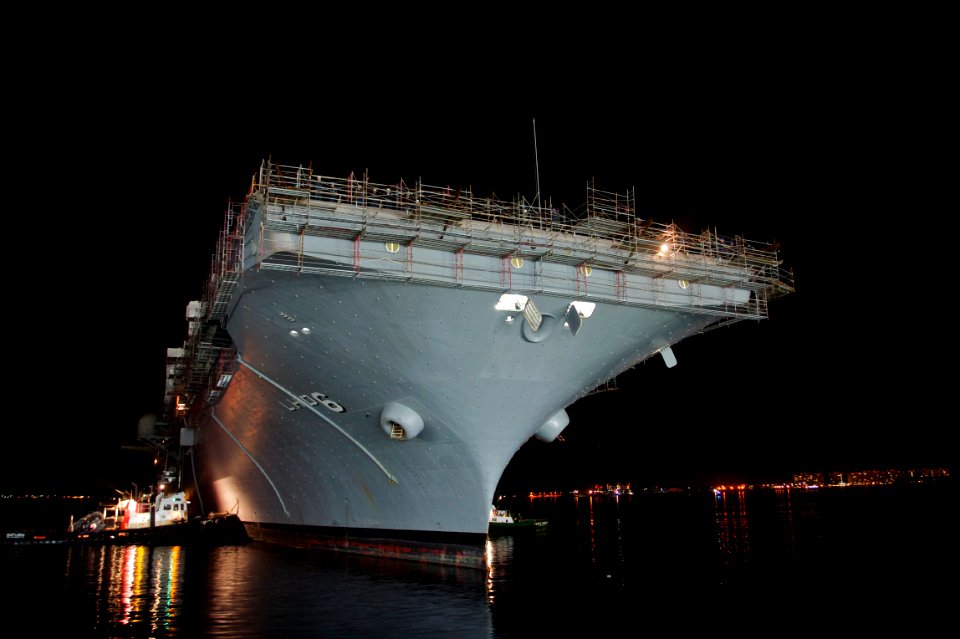 US Navy 101201-N-9643K-848 Tugboats maneuver the amphibious assault ship USS Bonhomme Richard (LHD 6) toward the NASSCO dry dock