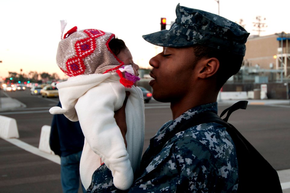 US Navy 101130-N-9123L-011 Boatswain's Mate Seaman Issac Doyle says goodbye to his daughter as he prepares to board the aircraft carrier USS Carl V