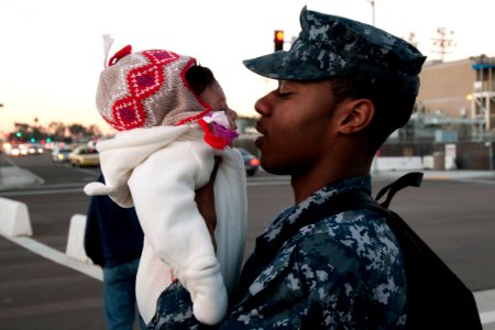 US Navy 101130-N-9123L-011 Boatswain's Mate Seaman Issac Doyle says goodbye to his daughter as he prepares to board the aircraft carrier USS Carl V