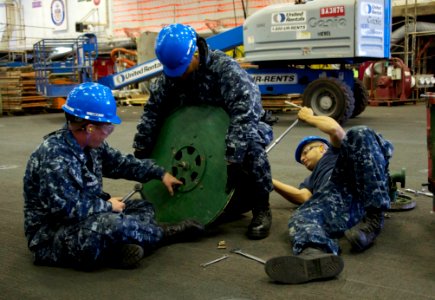 US Navy 101130-N-9643K-671 Sailors aboard the amphibious assault ship USS Bonhomme Richard (LHD 6) perform maintenance on a firehose reel station i