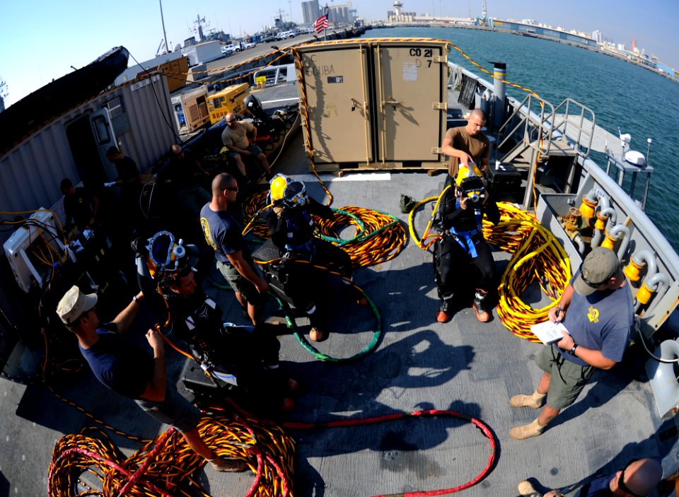 US Navy 101202-N-0413B-103 Navy divers assigned to Mobile Diving and Salvage Unit (MDSU) 2 prepare for a surface-supplied air dive aboard the Milit