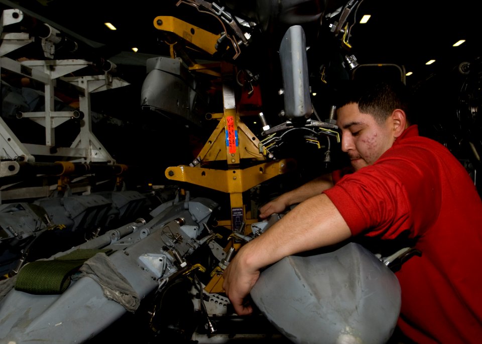 US Navy 101202-N-9626Y-073 Aviation Ordnanceman 3rd Class, Ruben Lolchado, from Fort Meade, Fla., performs maintenance on a multiple ejector rack a