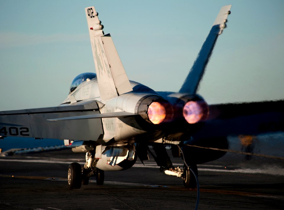 US Navy 101201-N-7981E-365 An F-A-18C Hornet assigned to Strike Fighter Squadron (VFA) 25 makes an arrested landing aboard the aircraft carrier USS