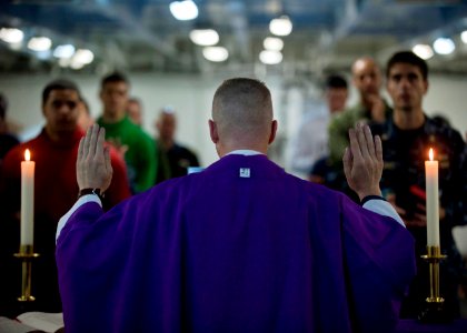 US Navy 101205-N-7981E-127 Cmdr. Keith Shuley, command chaplain of the aircraft carrier USS Carl Vinson (CVN 70), leads Sailors in prayer during Ro photo