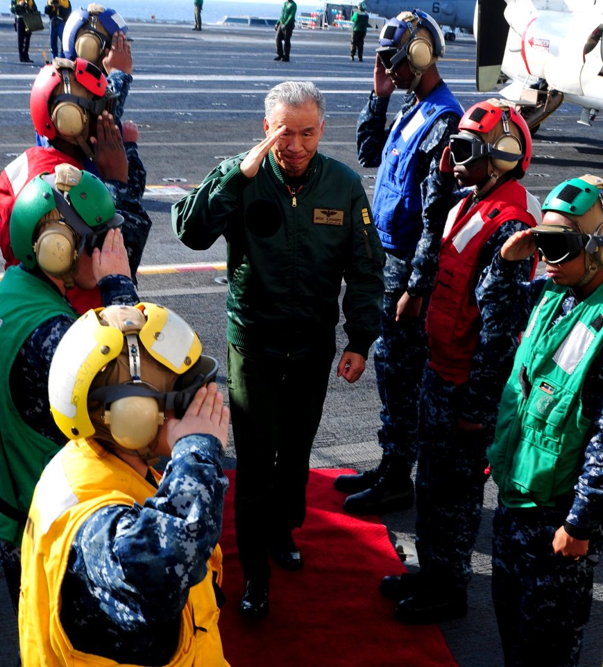 US Navy 101206-N-5538K-356 Japan Maritime Self-Defense Force Vice Adm. Kenichi Kuramoto walks through rainbow sideboys aboard the aircraft carrier
