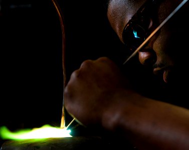 US Navy 101203-N-7981E-051 Hull Technician 3rd Class Oscar Williams III, assigned to the Engineering Department's R-1 Division, brazes tubing for a