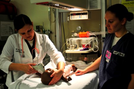 US Navy 101203-N-7364R-032 Hospital Corpsman Jordan Pehling, left, and Hospital Corpsman 3rd Class Amber Craig practice newborn care on a mannequin