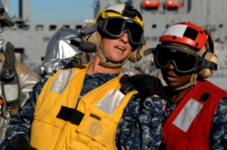 US Navy 101202-N-6477M-122 Aviation Boatswain's Mate Handling Airman Rodney Crowley, left, directs Aviation Support Equipment Technician 2nd Class