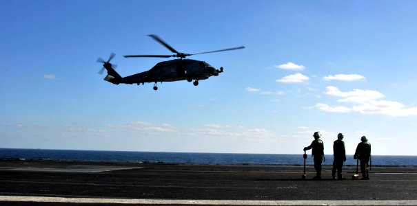 US Navy 101204-N-7103C-360 Sailors assigned to the Warlords of Helicopter Anti-Submarine Squadron Light (HSL) 51 wait for an SH-60B Seahawk to land