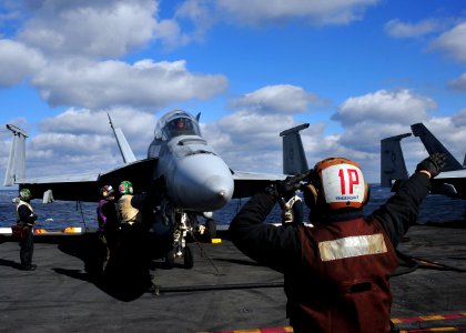 US Navy 101207-N-0569K-043 Capt. O.P. Honors conducts pre-flight checks as part of carrier flight re-qualifications in an F-A-18F Super Hornet