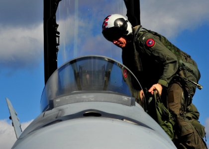 US Navy 101207-N-0569K-032 Capt. O.P. Honors climbs into the cockpit of an F-A-18F Super Hornet