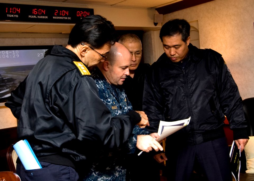 US Navy 101204-N-9626Y-010 apt. William Wagner, center, commander of Destroyer Squadron (DESRON) 15 briefs Japan Maritime Self-Defense Force admira