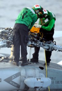 US Navy 101205-N-2055M-151 Sailors assigned to Helicopter Anti-Submarine Squadron (HS) 15 perform maintenance on a SH-60F Sea Hawk helicopter aboar