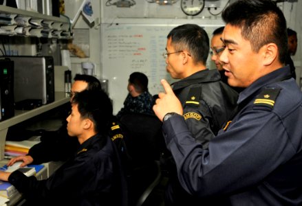 US Navy 101204-N-7103C-015 Military officials from the Japan Maritime Self-Defense Force communicate with Japanese ships in the joint forces air co
