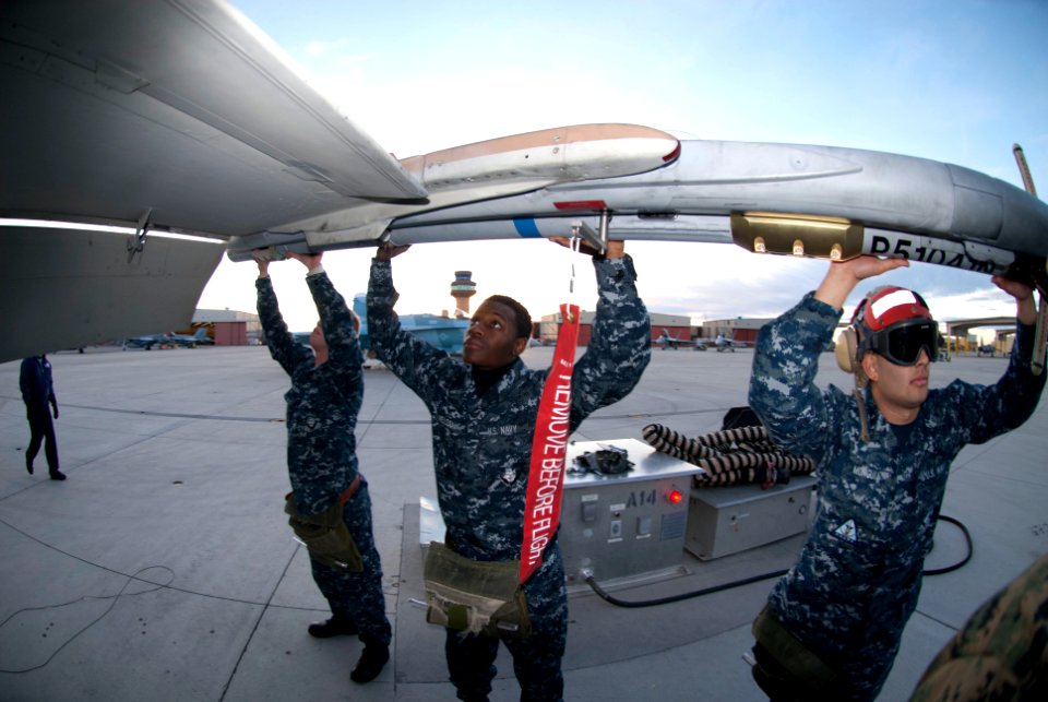 US Navy 101207-N-6770T-233 Sailors assigned to Naval Strike and Air Warfare Center unload ordnance from an F-A-18E after a daytime training mission