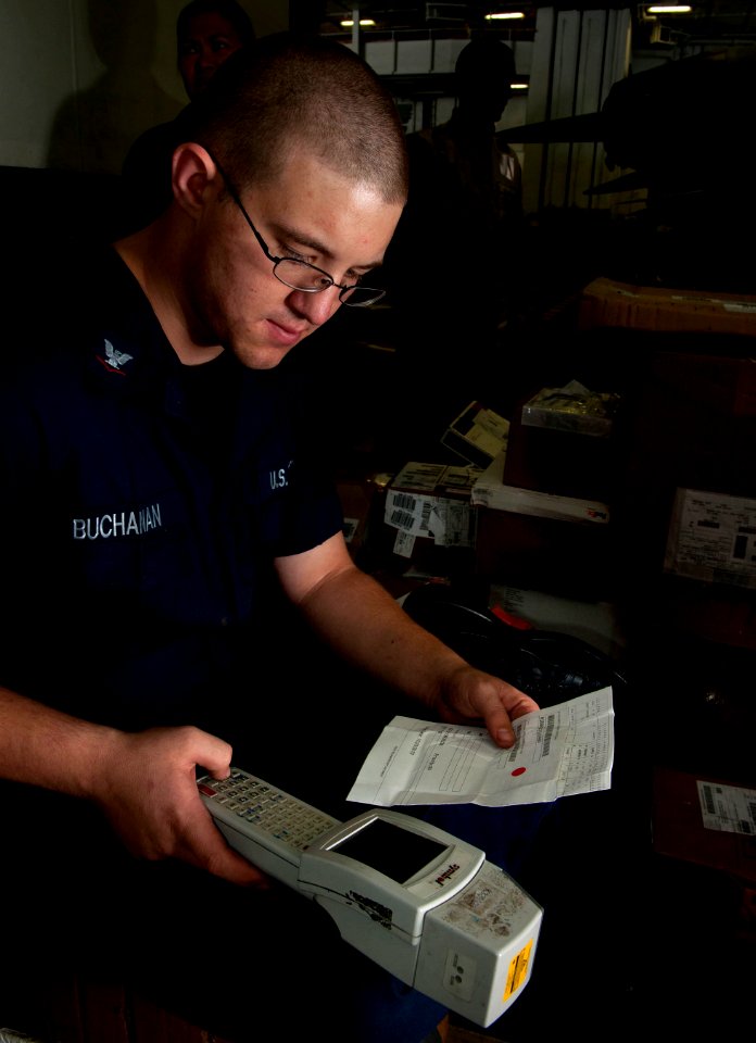 US Navy 101203-N-7981E-245 Logistics Specialist 3rd Class Maston Buchanan, shipping and receiving supervisor for the Supply Department's S-8 Divis