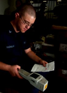 US Navy 101203-N-7981E-245 Logistics Specialist 3rd Class Maston Buchanan, shipping and receiving supervisor for the Supply Department's S-8 Divis