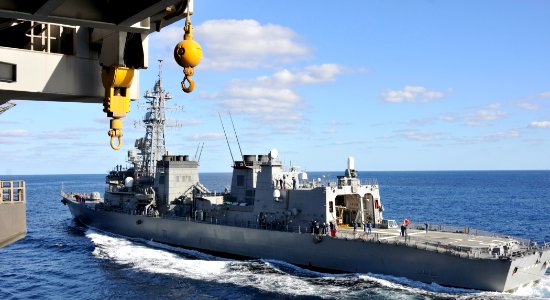 US Navy 101205-N-7103C-016 The Japan Maritime Self-Defense Force destroyer Ikazuchi (DD 107) maneuvers alongside the aircraft carrier USS George Wa