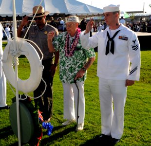 US Navy 101207-N-3666S-152 Sterling Cale lays a wreath during a ceremony commemorating the 69th anniversary of the attack on Pearl Harbor