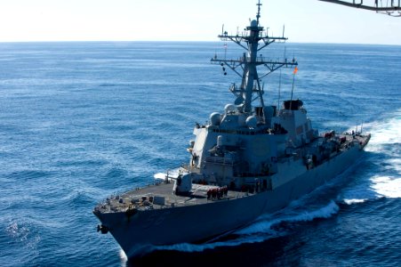 US Navy 101205-N-9626Y-137 The guided-missile destroyer USS John S. McCain (DDG 56) approaches the aircraft carrier USS George Washington (CVN 73)