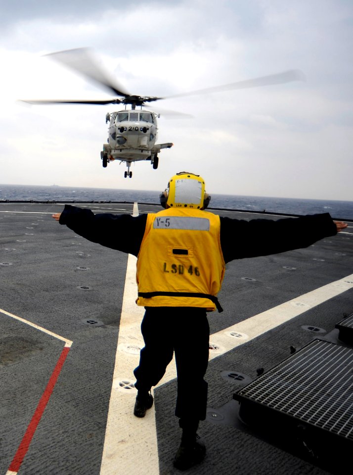 US Navy 101207-N-8335D-911 Boatswain's Mate Seaman Josh Hiner directs a Japan Maritime Self-Defense Force SH-60K Sea Hawk helicopter