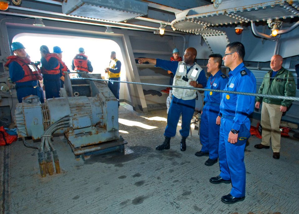 US Navy 101205-N-6720T-004 Chief Boatswain's Mate Melvin Morris discusses refueling operations with Japan Maritime Self-Defense Force master chiefs