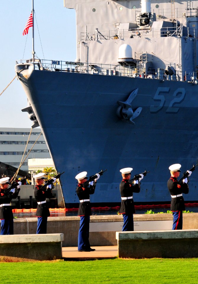 US Navy 101207-N-7948R-606 Marines assigned to 3rd Radio Battalion, Marine Corps Base Keneohe Bay, fire a rifle salute in front of the amphibious d