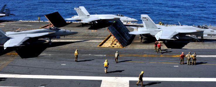 US Navy 101204-N-7103C-172 Sailors aboard the aircraft carrier USS George Washington (CVN 73) ready F-A-18 Hornet strike fighters for launch during