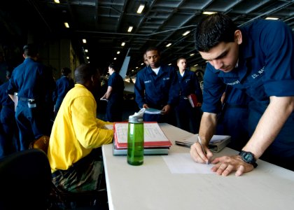 US Navy 101205-N-9626Y-007 Aviation Structural Mechanic Airman Jonathon Darragh, right, from Jacksonville, Fla., signs up for a warfare walk-throug