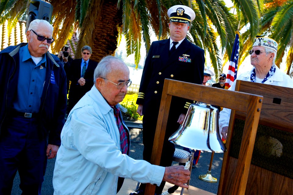 US Navy 101207-N-8863V-497 Roger Marron, 90, center, rings a bell at Naval Surface Warfare Center, Corona Division during a ceremony commemorating