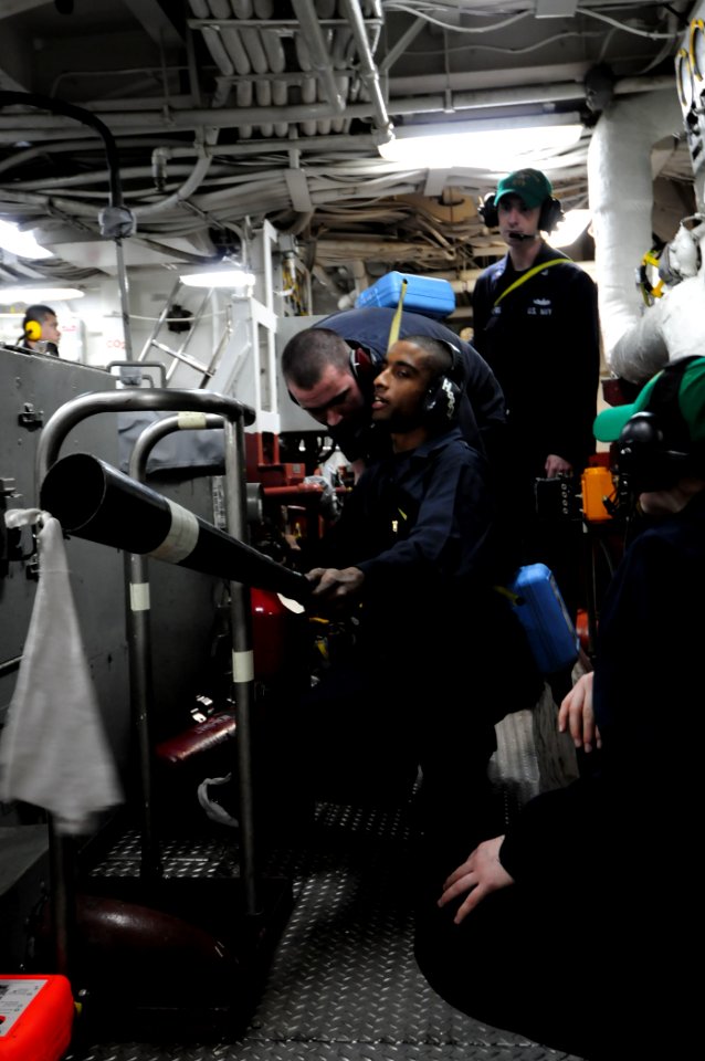 US Navy 101208-N-3659B-318 Engineman 3rd Class Kevin Hobdy mans a fire bottle and reports the status of a simulated engineering casualty in auxilia