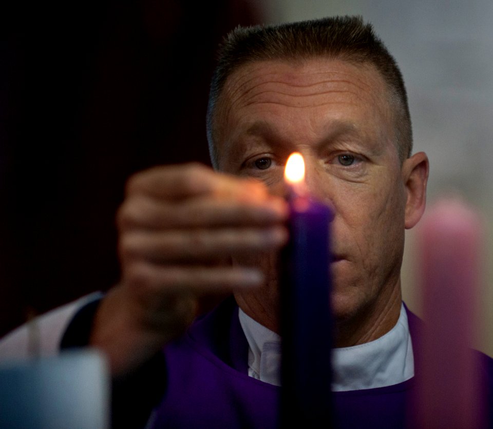 US Navy 101205-N-7981E-014 Cmdr. Keith Shuley, command chaplain of the aircraft carrier USS Carl Vinson (CVN 70), lights candles during Roman Catho