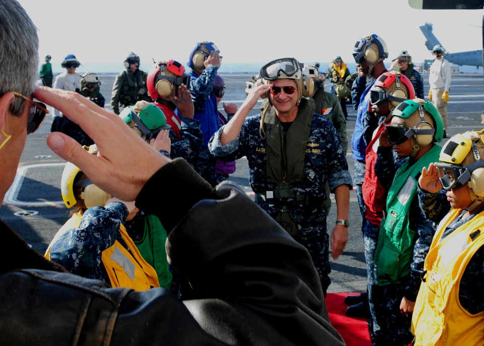 US Navy 101206-N-5538K-303 Rear Adm. Richard Landolt, commander of Amphibious Force U.S 7th Fleet, walks through rainbow sideboys aboard the aircra