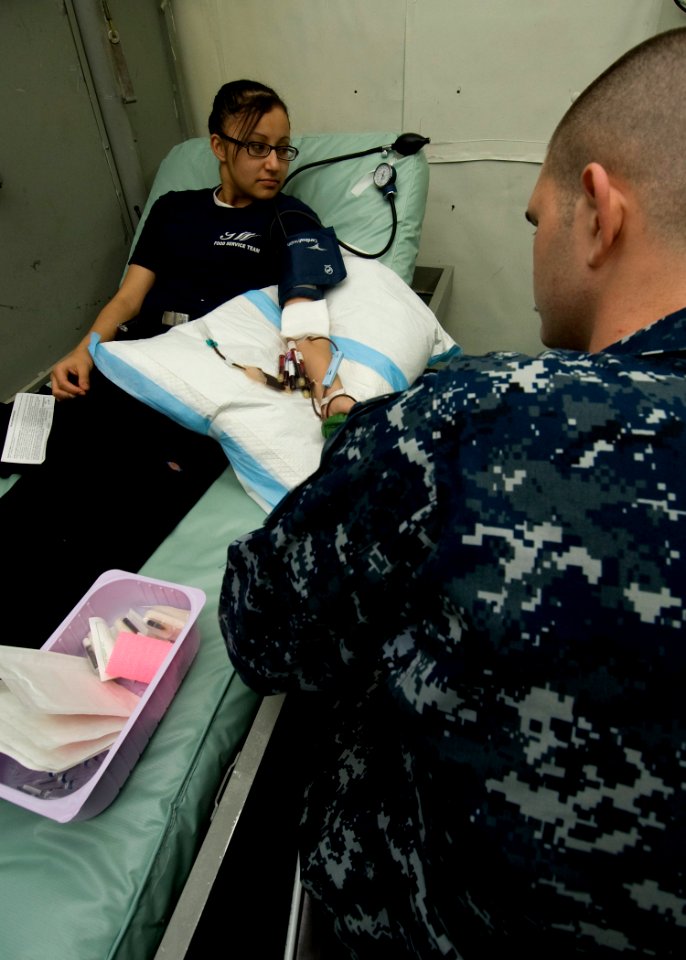 US Navy 101205-N-9626Y-036 Aviation Ordnanceman Airman Amanda Longie, from Busey, Mont., donates blood aboard the aircraft carrier USS George Wash