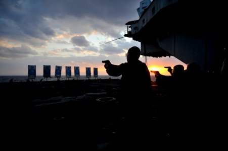 US Navy 101209-N-2013O-165 Sailors aim their M-9 9mm pistols down range during a small-arms qualification aboard USS George Washington (CVN 73)