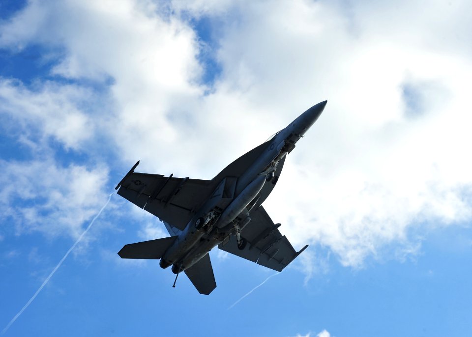 US Navy 101207-N-0569K-104 Capt. O.P. Honors flies over the ship's flight deck during carrier flight re-qualifications with an F-A-18F Super Hornet