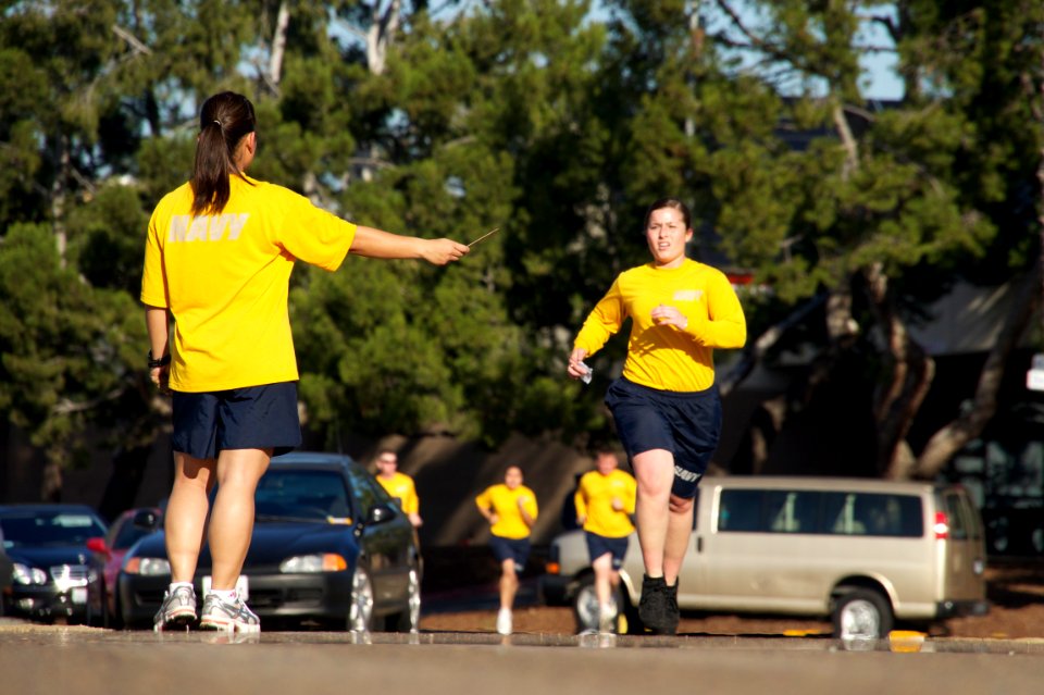 US Navy 101209-N-9643K-870 A Sailor gets a time-marker as she completes the 1.5-mile run portion of the semi-annual physical fitness test at Naval